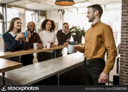 smiley people having coffee during meeting