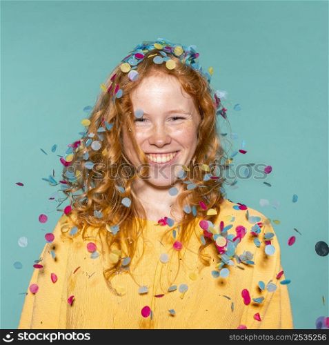 smiley redhead woman partying with confetti her hair
