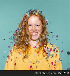 smiley redhead woman partying with confetti her hair