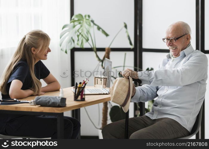 smiley senior man nursing home with nurse