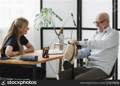 smiley senior man nursing home with nurse