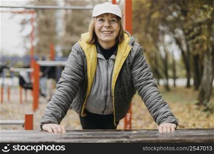 smiley senior woman working out outdoors 2