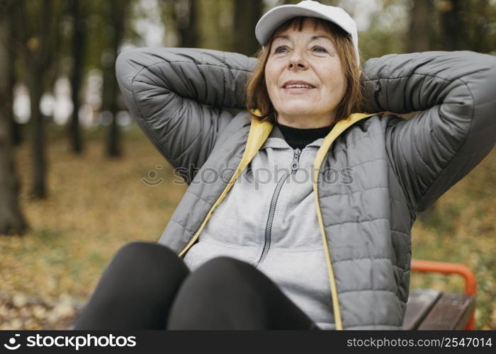 smiley senior woman working out outdoors