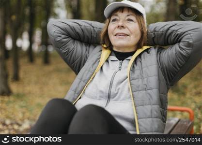 smiley senior woman working out outdoors