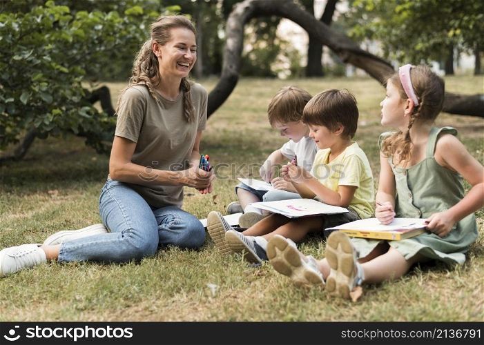 smiley teacher kids outdoors