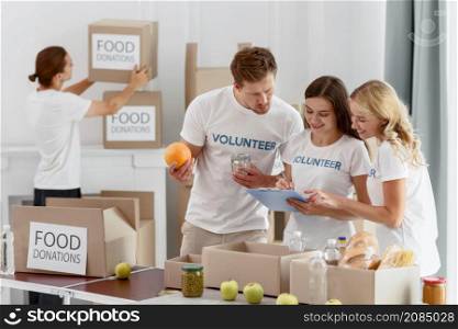 smiley volunteers preparing food charity