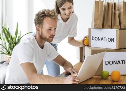 smiley volunteers using laptop