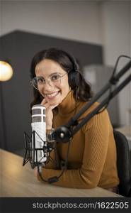 smiley woman broadcasting radio with headphones microphone