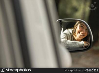 smiley woman car while road trip