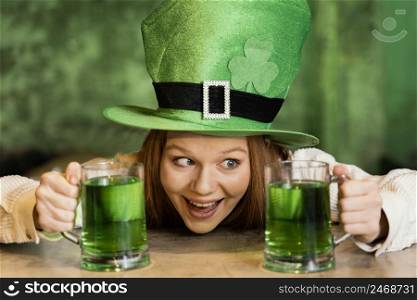 smiley woman celebrating st patrick s day with drinks