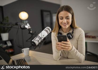 smiley woman doing radio with microphone smartphone