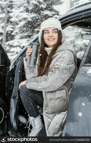 smiley woman enjoying snow while road trip