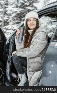 smiley woman enjoying snow while road trip