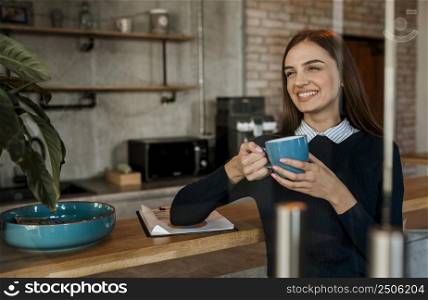 smiley woman having coffee during meeting