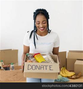 smiley woman holding box donations