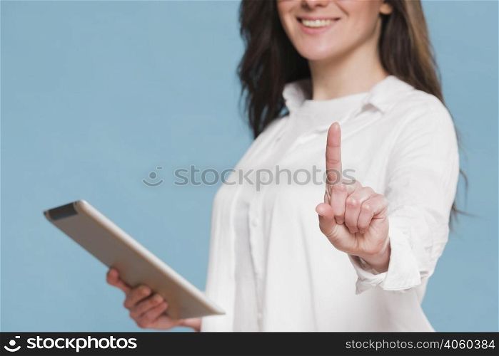 smiley woman holding digital tablet