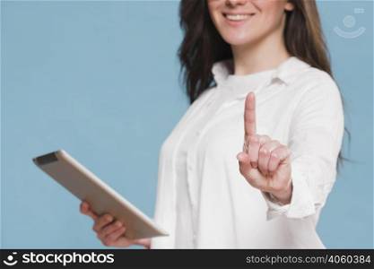 smiley woman holding digital tablet