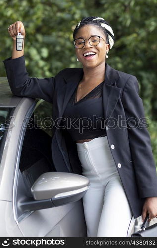 smiley woman holding up her car keys