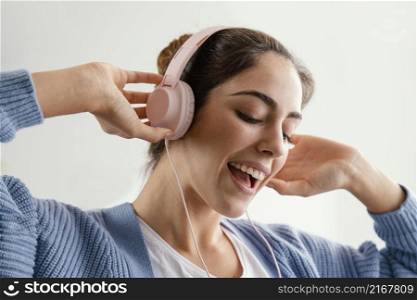 smiley woman listening music headphones