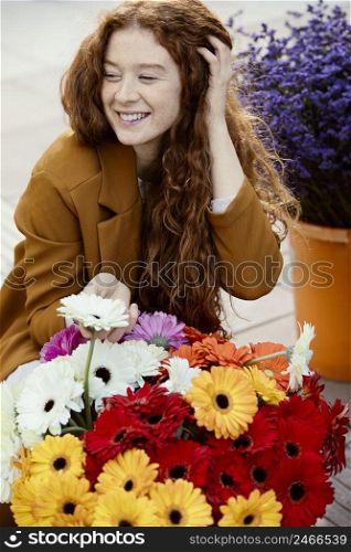 smiley woman outdoors spring with bouquet flowers