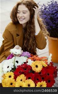 smiley woman outdoors spring with bouquet flowers
