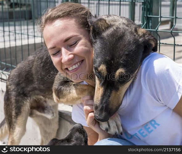 smiley woman playing with cute dog up adoption