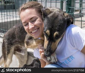 smiley woman playing with cute dog up adoption