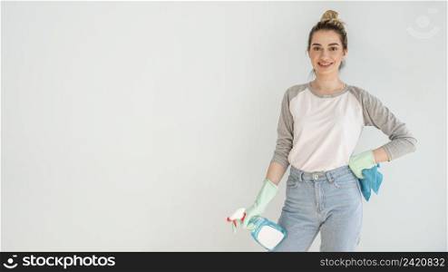 smiley woman posing while holding cleaning solution cloth