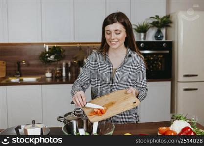 smiley woman preparing food kitchen