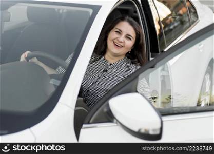 smiley woman sitting driver seat