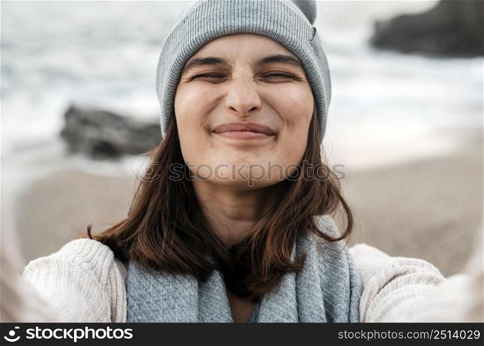 smiley woman taking selfie beach