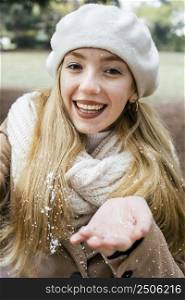 smiley woman taking selfie park during winter with snow