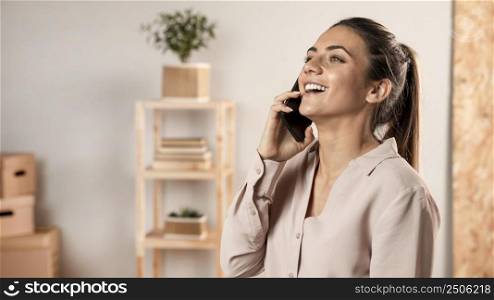 smiley woman talking phone medium shot