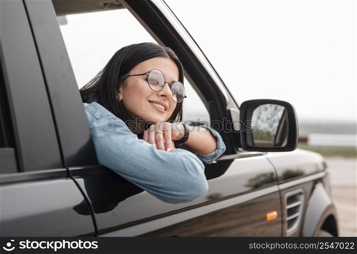 smiley woman traveling alone by car