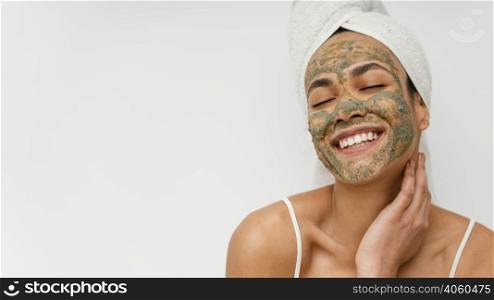 smiley woman with natural face mask copy space