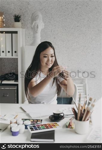 smiley woman with painting palettes