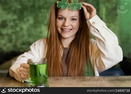 smiley woman with shamrock glasses celebrating st patrick s day bar
