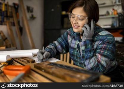 smiley woman workshop talking phone