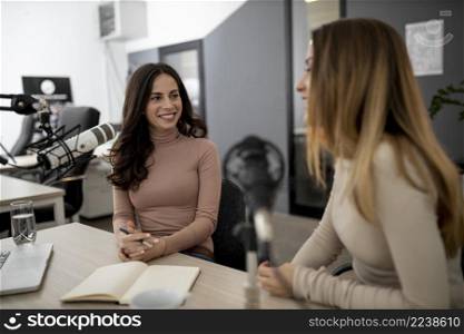 smiley women broadcasting radio together