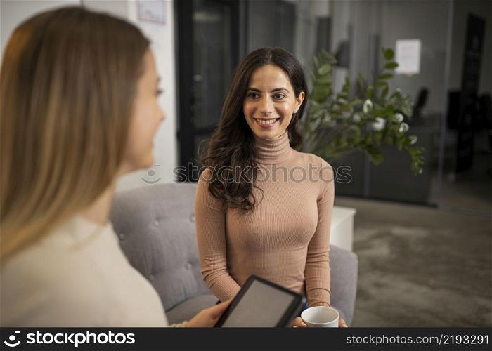 smiley women doing radio interview together