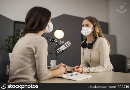 smiley women doing radio with medical masks