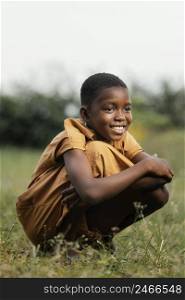 smiley young african boy standing field 2
