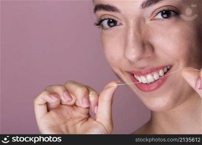 smiley young girl using floss
