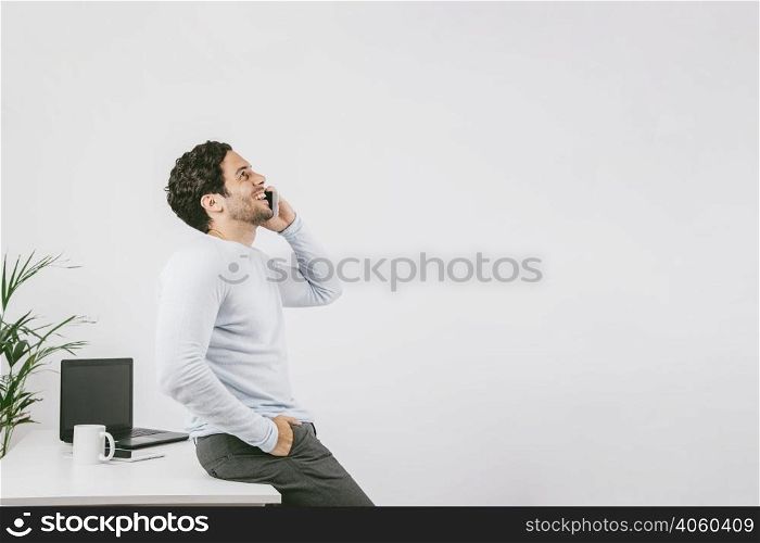smiley young man office talking phone