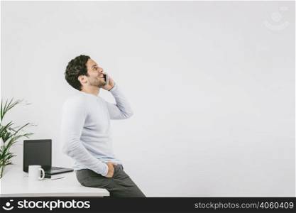 smiley young man office talking phone
