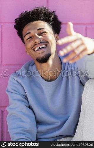 smiley young man outdoor sitting