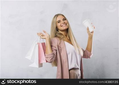 smiley young woman holding shopping bags