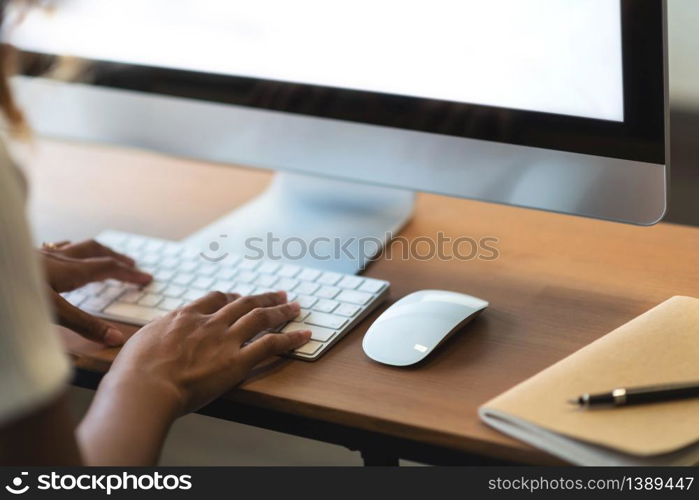 Smiling African American Woman working on Computer. Happy creative female Designer is doing graphic design at the office studio. Online shopping.