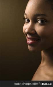 Smiling African-American young adult female looking at viewer.