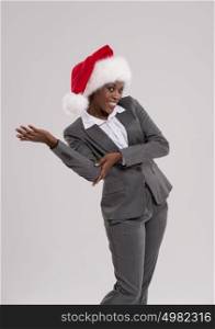 Smiling african Santa Girl presenting your product, lots of copyspace
